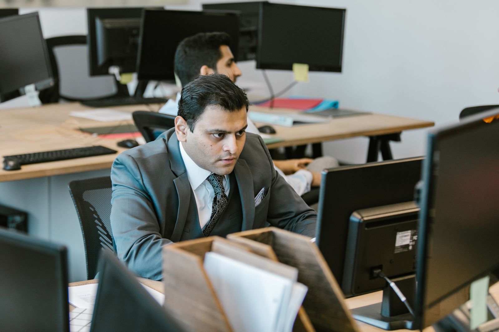 A professional working at a computer in a modern office
