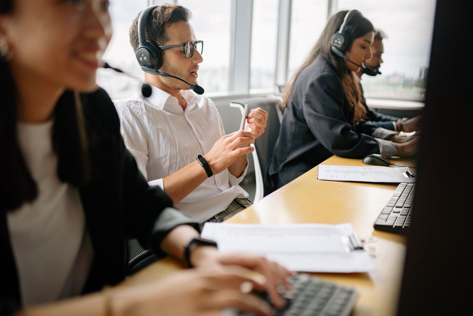 A support team working at desks in a modern office