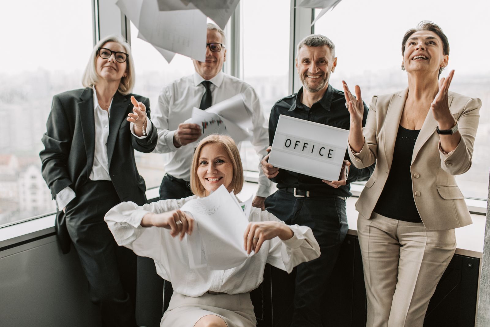 A group of colleagues celebrating together in an office